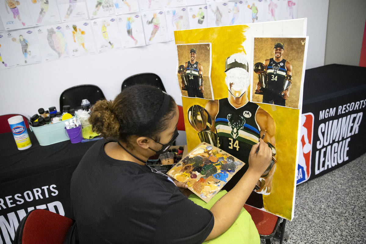 Keely Jackson, a NBA Summer League intern for the third year in a row, does a live painting of ...