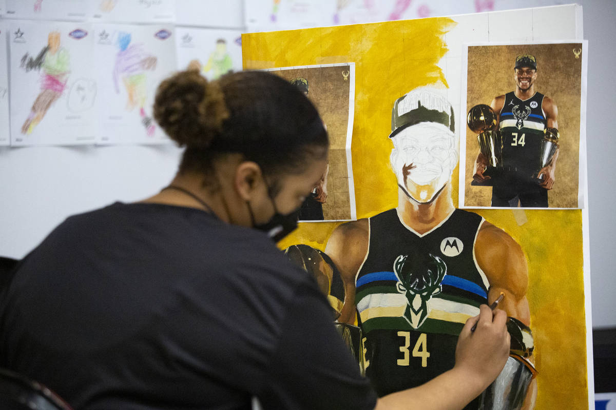 Keely Jackson, a NBA Summer League intern for the third year in a row, does a live painting of ...