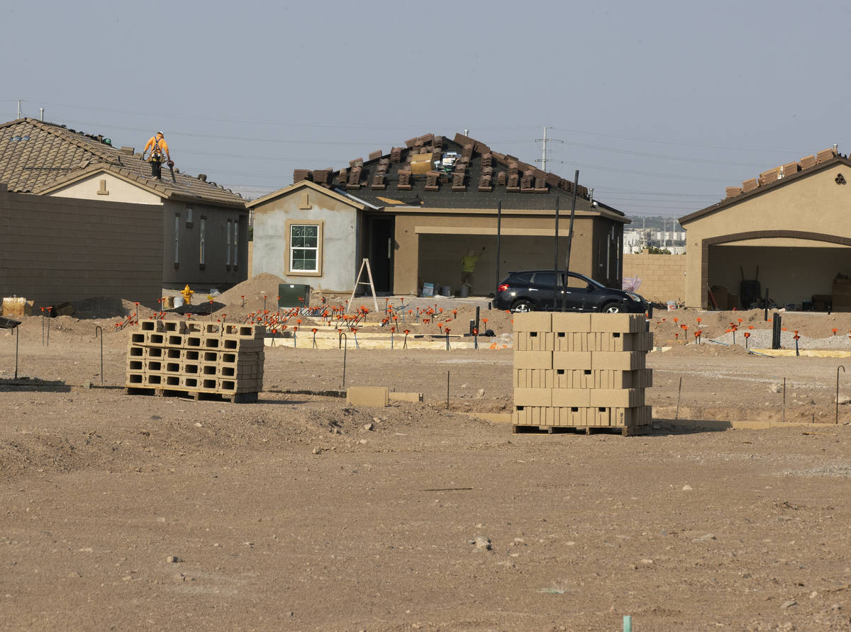 Construction crews work at the Rhapsody subdivision by developer StoryBook Homes in Henderson's ...