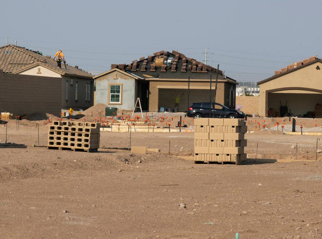 Construction crews work at the Rhapsody subdivision by developer StoryBook Homes in Henderson's ...