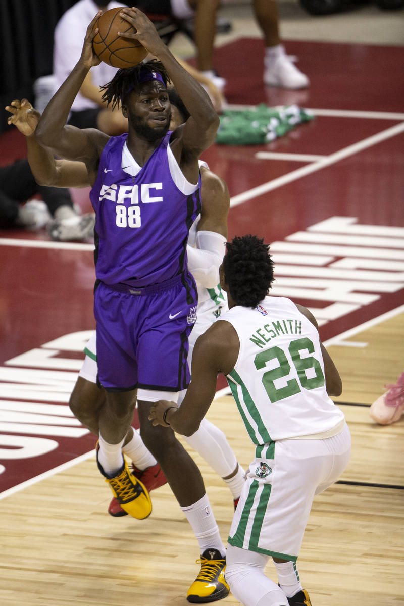 Sacramento Kings center Neemias Queta (88) looks to pass while guarded by Boston Celtics forwar ...