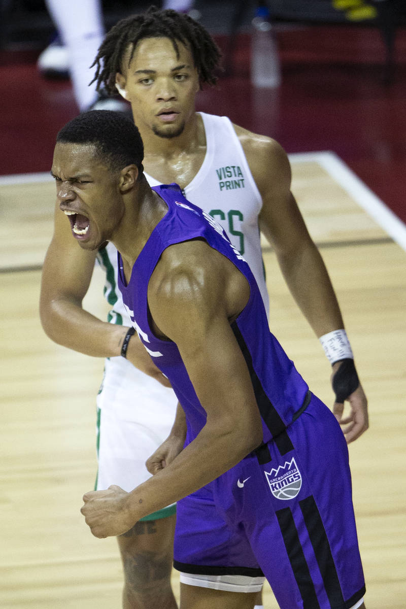 Sacramento Kings guard Jahmi'us Ramsey (3) celebrates after dunking while Boston Celtics guard ...