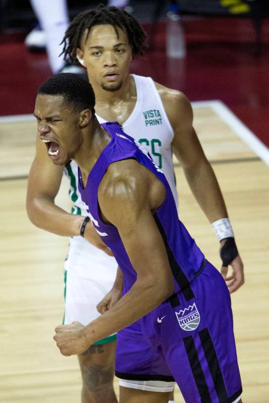 Sacramento Kings guard Jahmi'us Ramsey (3) celebrates after dunking while Boston Celtics guard ...