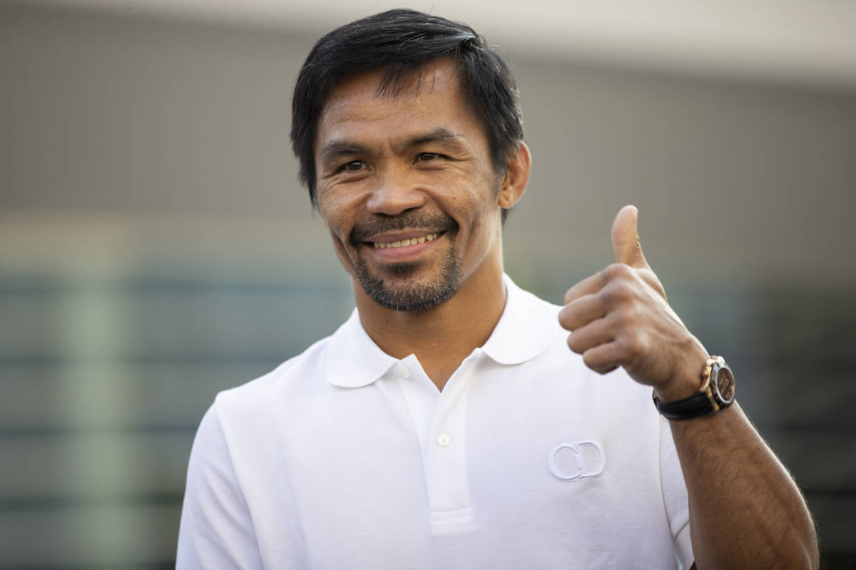 Manny Pacquiao gestures at the crowd during his grand arrival at Toshiba Plaza in Las Vegas, Tu ...