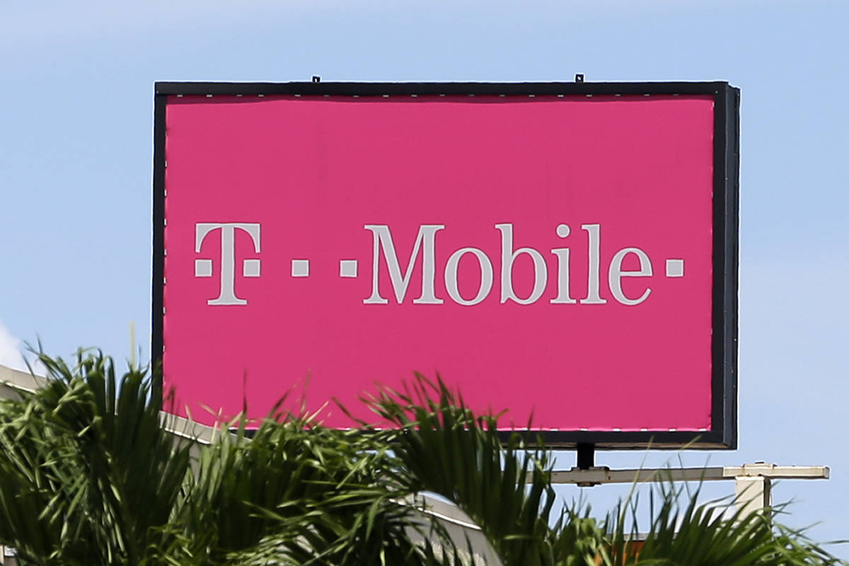 This photo taken Thursday, July 27, 2017, shows T Mobile sign at a store in Hialeah, Fla. T-Mo ...