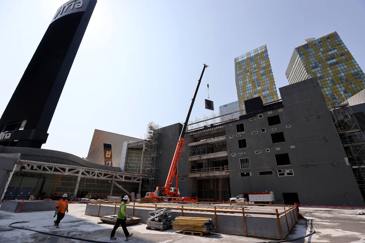 Workers dismantle the south core of the former Harmon hotel to make room for a four-story retai ...