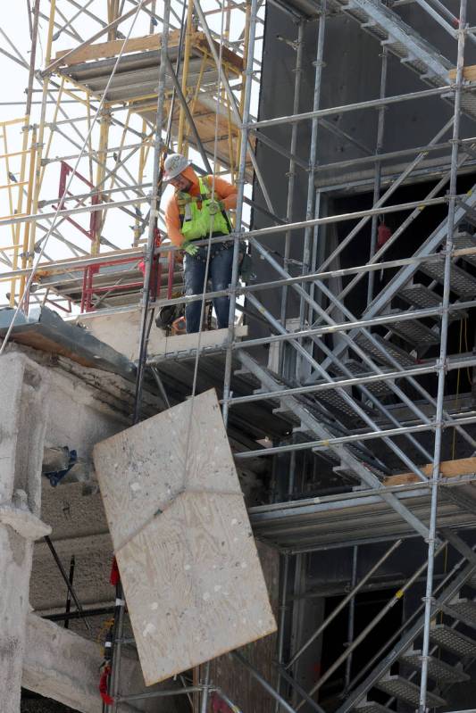 Workers dismantle the south core of the former Harmon hotel to make room for a four-story retai ...