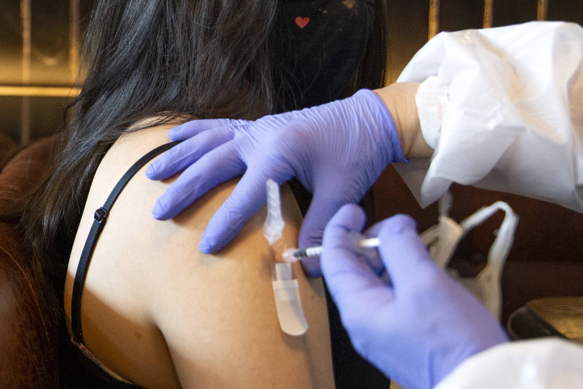 Audrey Vallapudua, of Las Vegas, receives the Pfizer COVID-19 vaccine during a pop-up vaccinati ...