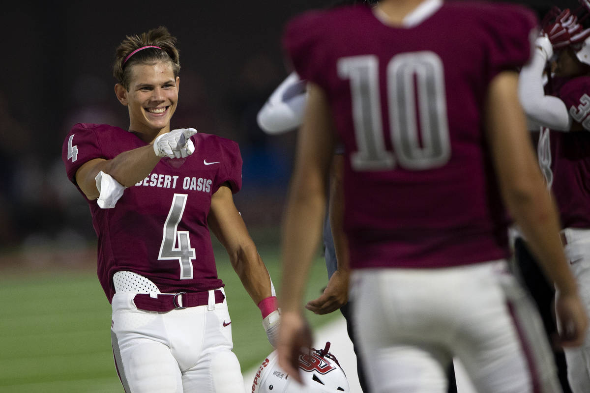 Desert Oasis running back Isaiah Flasher (4) laughs with his teammates on the sidelines during ...