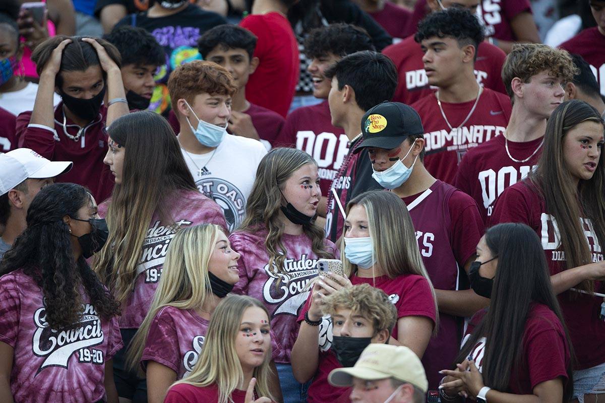 Desert Oasis fans, some wearing masks to prevent the spread of COVID-19 and others not, pack th ...