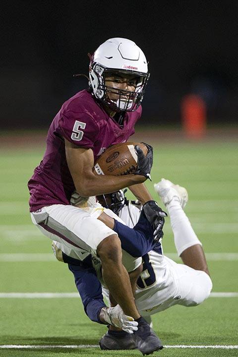 Desert Oasis wide receiver Vonnharold Rivera is tackled by Spring Valley during a high school f ...
