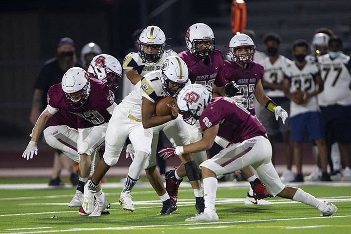 Spring Valley quarterback Ti'Shaun Ereaux-Jackson (1) is about to be tackled by Desert Oasis wi ...