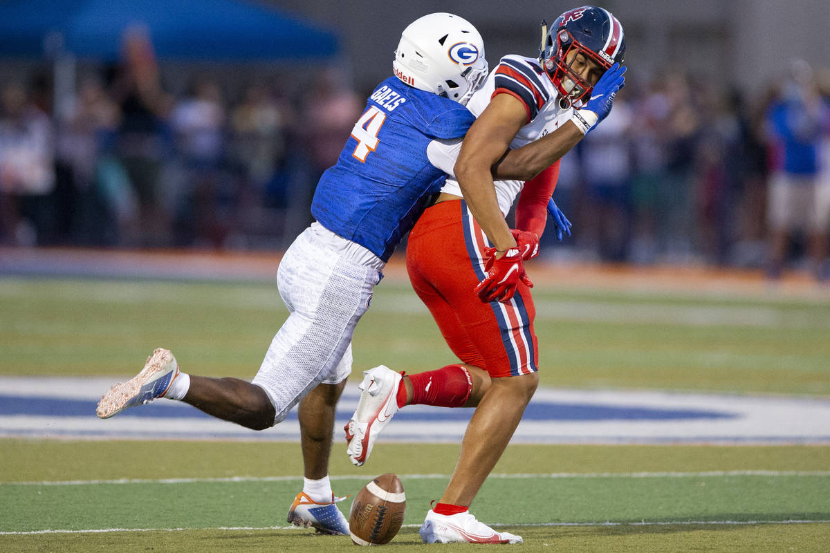 Bishop Gorman's Cam'ron Barfield (4 ) breaks a pass intended for St. Louis Devon Tauefa (4) du ...