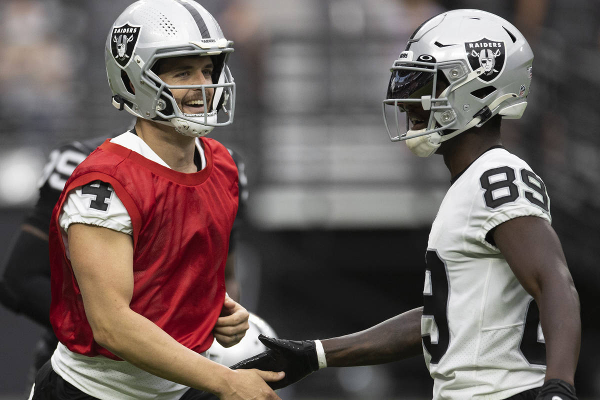 Raiders quarterback Derek Carr (4) and Raiders wide receiver Bryan Edwards (89) celebrate a big ...