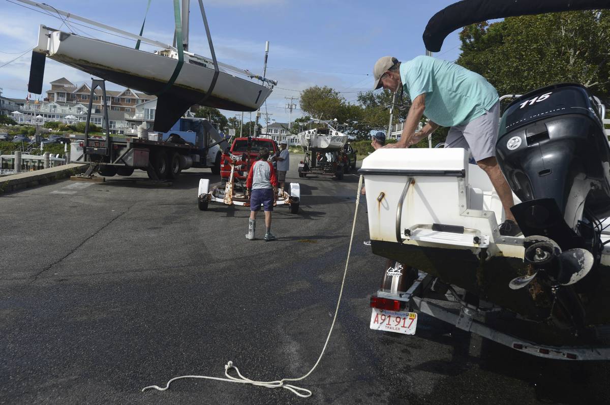 Baxter Crane Company hauls one of the Hyannis Yacht Club J22 sailboats onto a trailer at the Ga ...