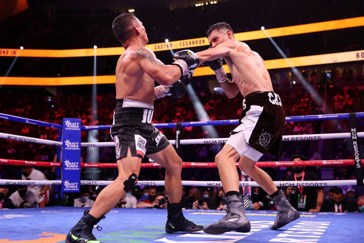 Carlos Castro, left, connects a punch against Oscar Escandon, in the 10th round of the featherw ...