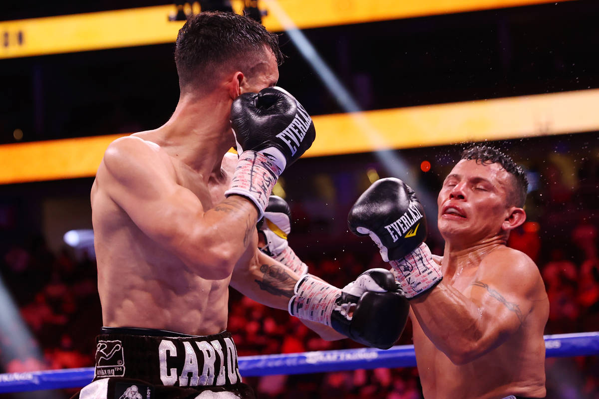 Carlos Castro, left, connects a punch against Oscar Escandon, in the ninth round of the feather ...