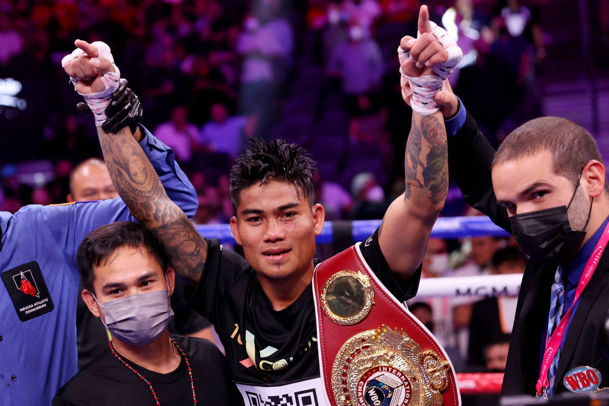 Mark Magsayo raises his arms in victory after his 10th round knockout win against Julio Ceja in ...