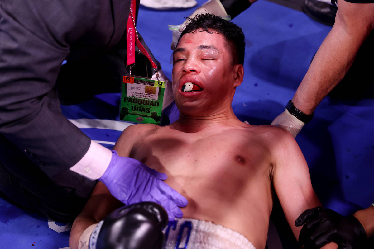 Julio Ceja receives assistance after getting knocked out by Mark Magsayo in round 10th of the f ...