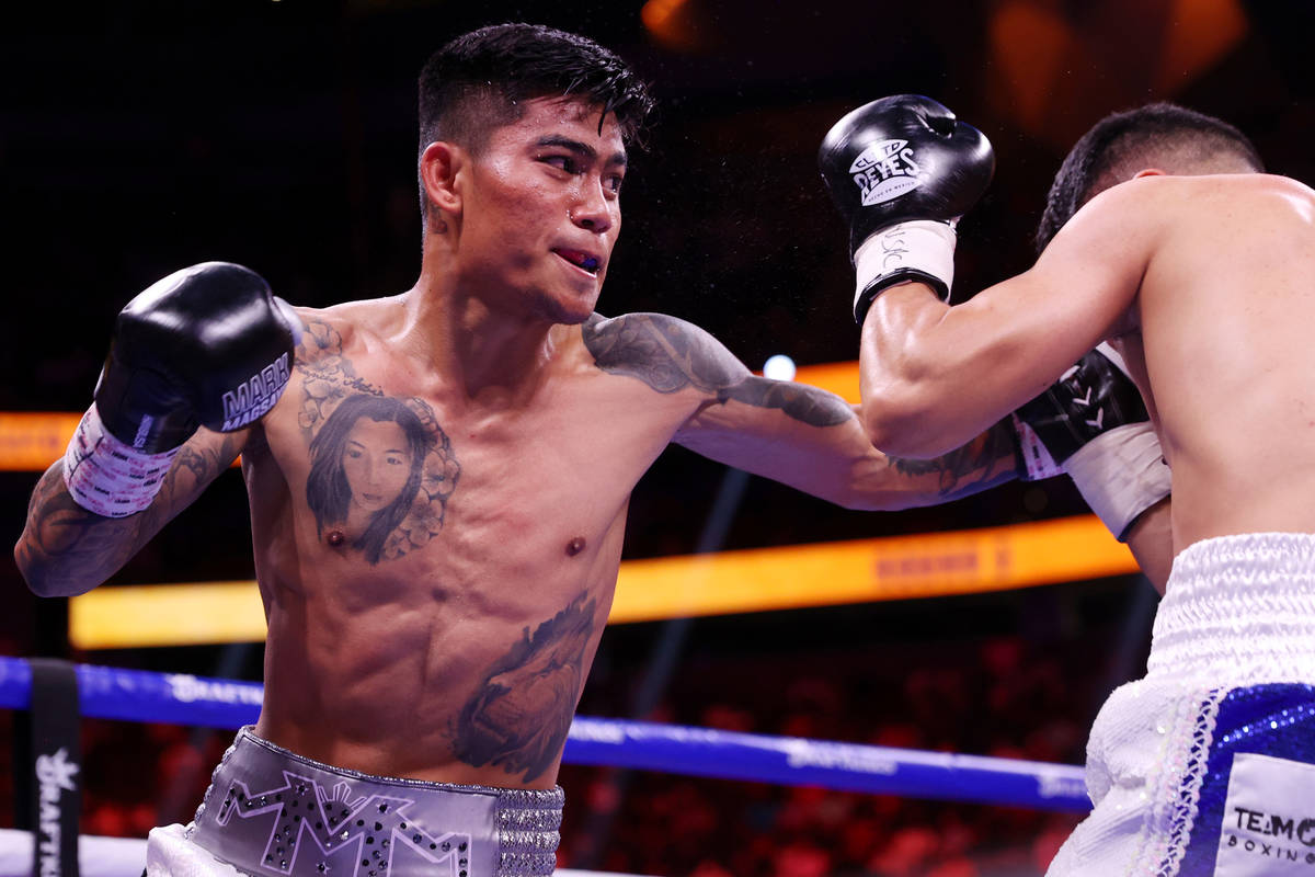 Mark Magsayo connects a punch against Julio Ceja in the third round of the featherweight bout a ...