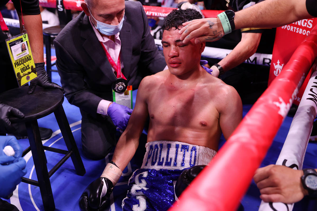 Julio Ceja receives assistance after getting knocked out by Mark Magsayo in round 10th of the f ...