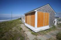 A beach house on East Matunuck beach in South Kingstown, R.I., is boarded up in preparation for ...