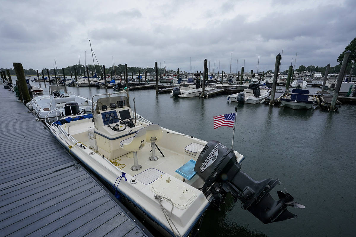 Storm clouds loom over boats docked at a marina in Branford, Conn., Sunday, Aug. 22, 2021 as Tr ...