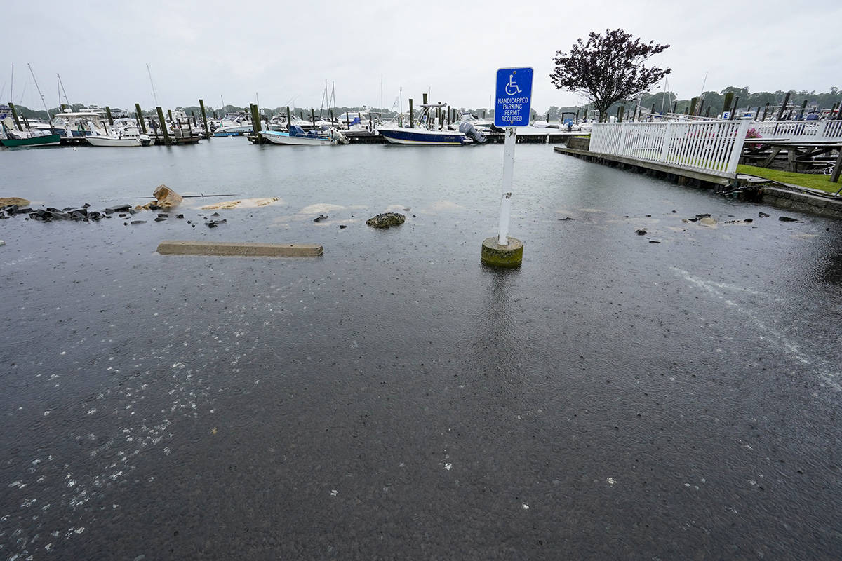 The parking lot of a marina is flooded during high tide, Sunday, Aug. 22, 2021, in Branford, Co ...