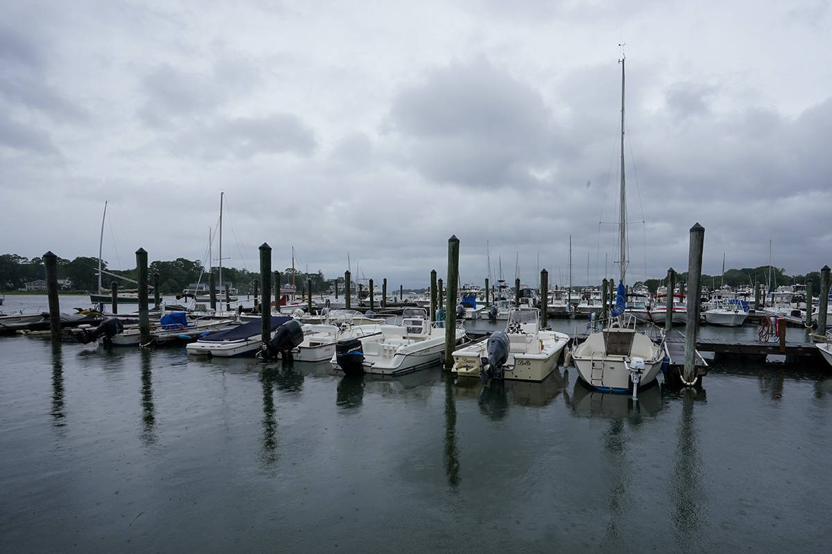 Storm clouds loom over boats docked at a marina in Branford, Conn., Sunday, Aug. 22, 2021 as Tr ...