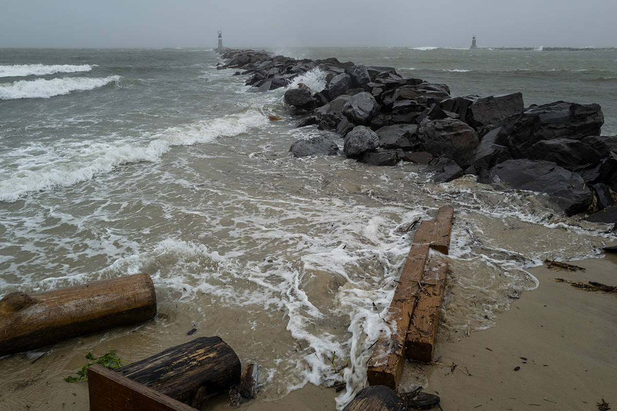Waves pound a jetty in Montauk, N.Y., Sunday, Aug. 22, 2021, as Tropical Storm Henri affects th ...