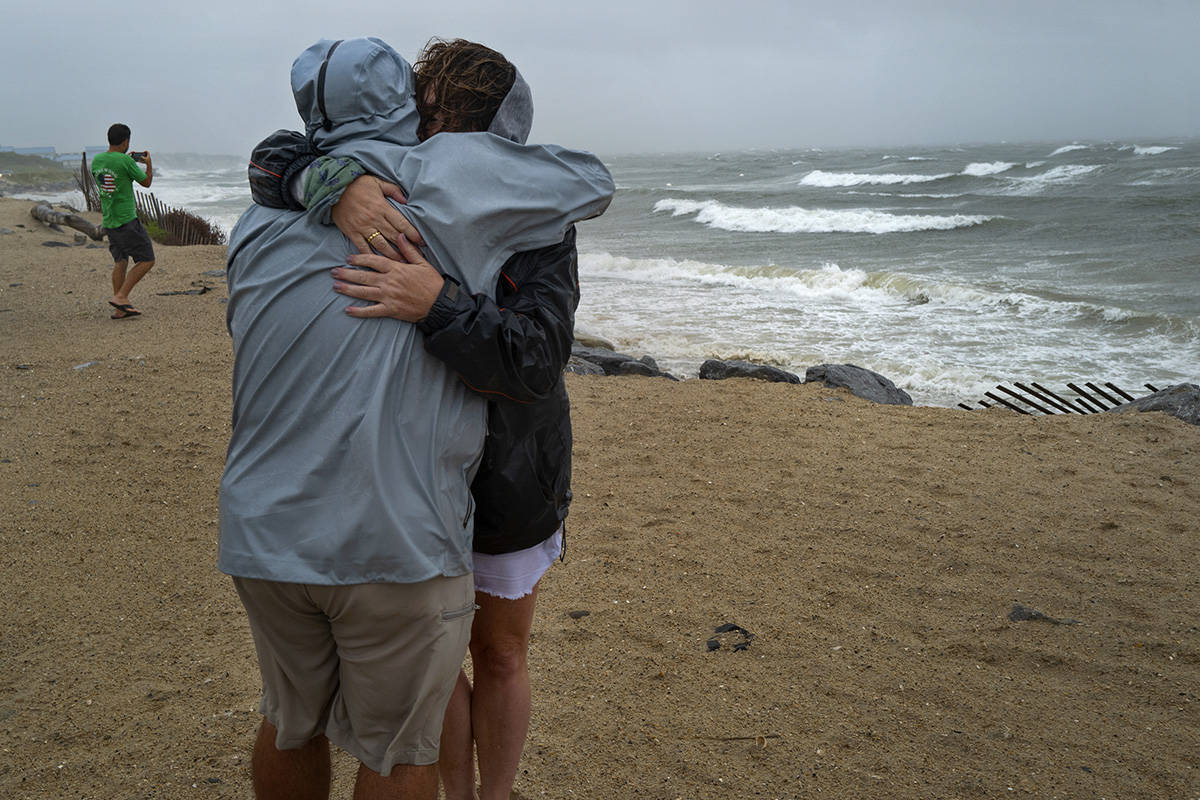 Cliona Becker Stratford, Conn. and Andrew Licata, of Jersey City, NJ, experience the wind and w ...