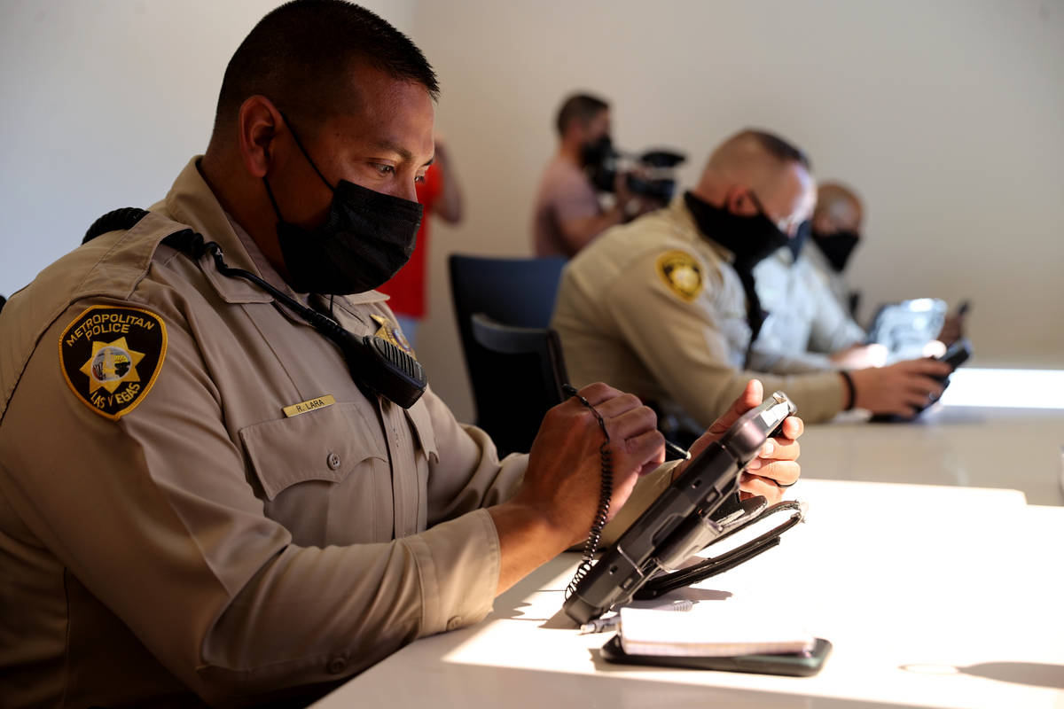 Las Vegas police officers, including Ricky Lara, left, work in the Las Vegas police community i ...