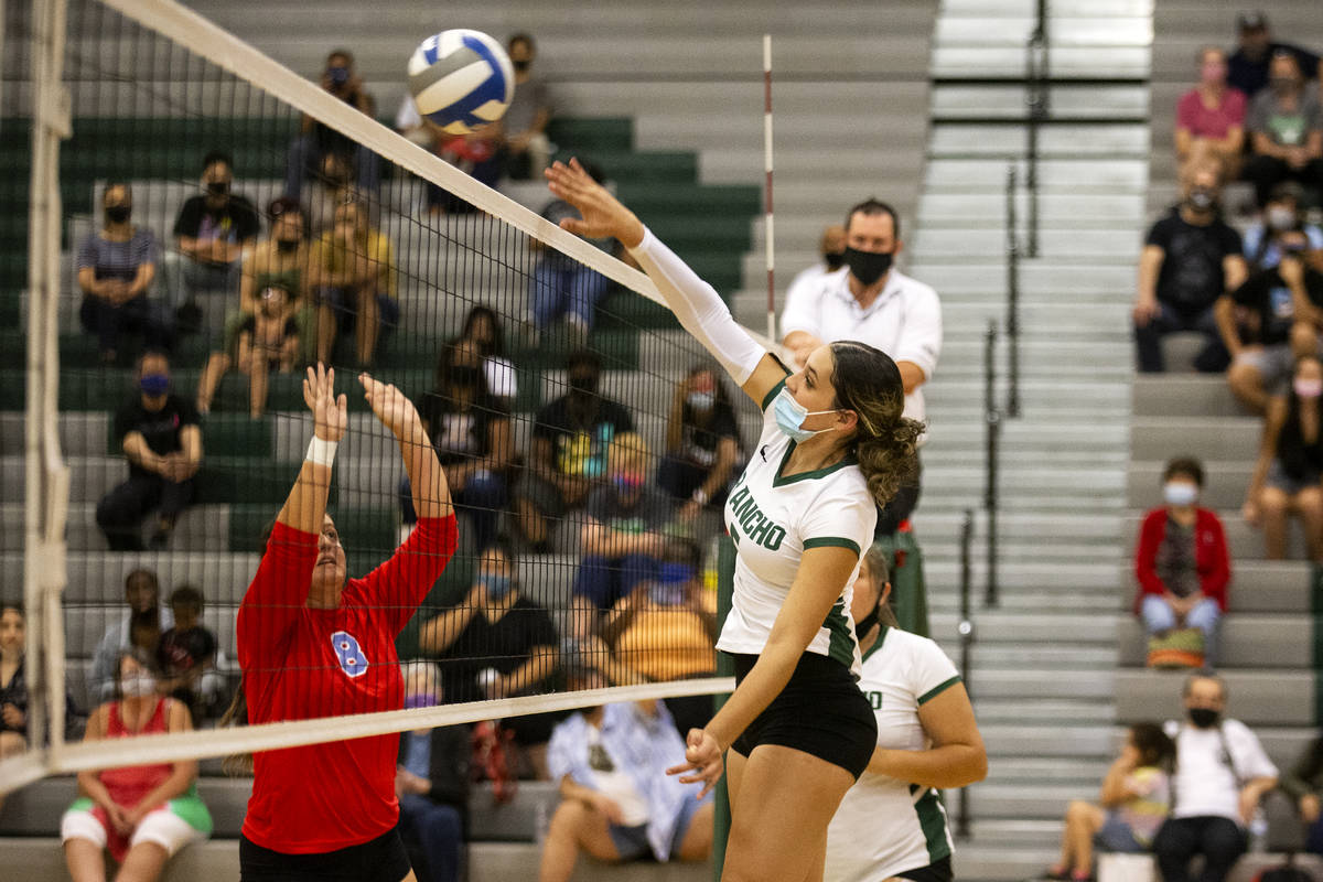 Rancho's Summer Martin (5) kills the ball while Western's Mia Perez (8) jumps to block during t ...