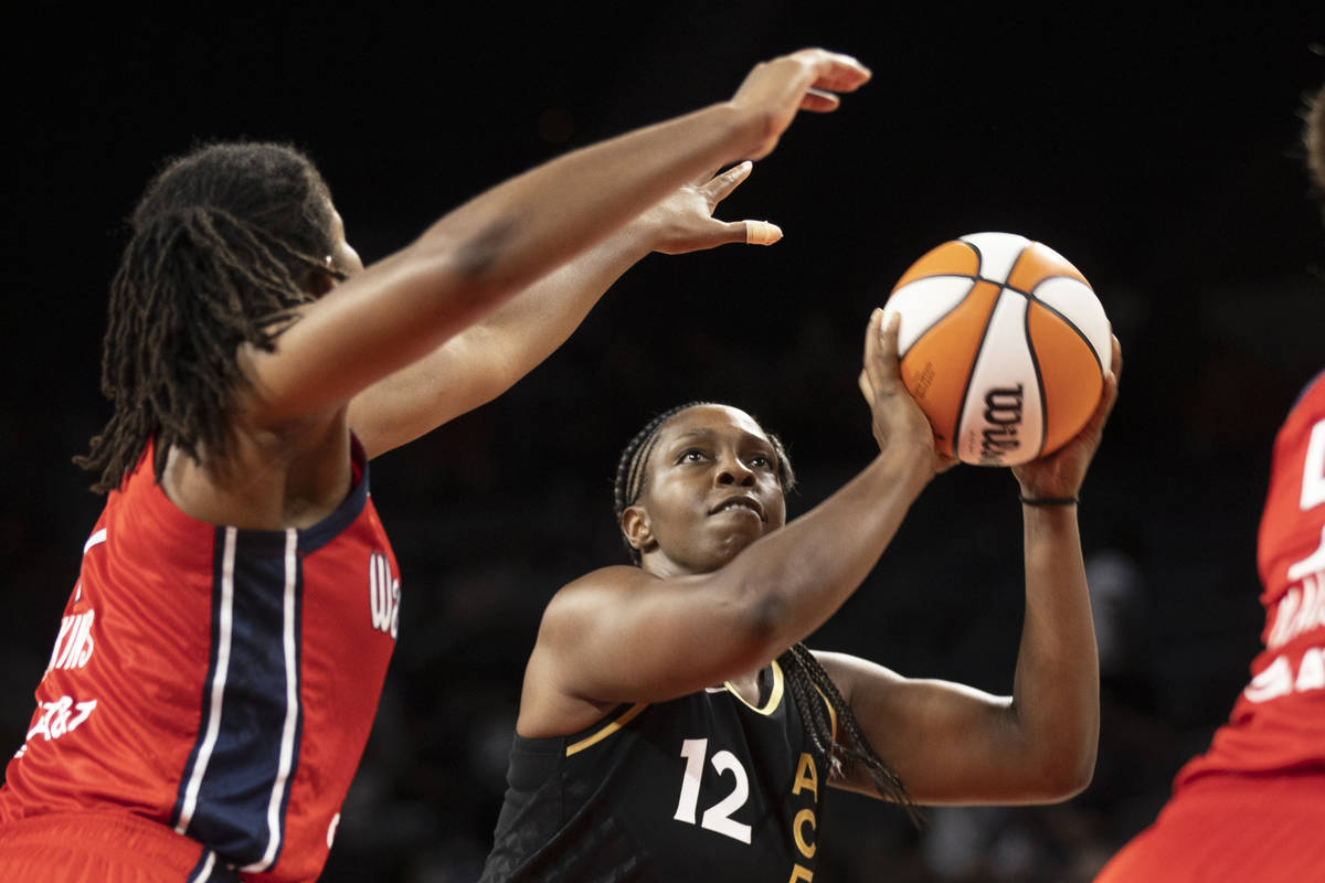 Las Vegas Aces guard Chelsea Gray (12) shoots over Washington Mystics forward Theresa Plaisance ...