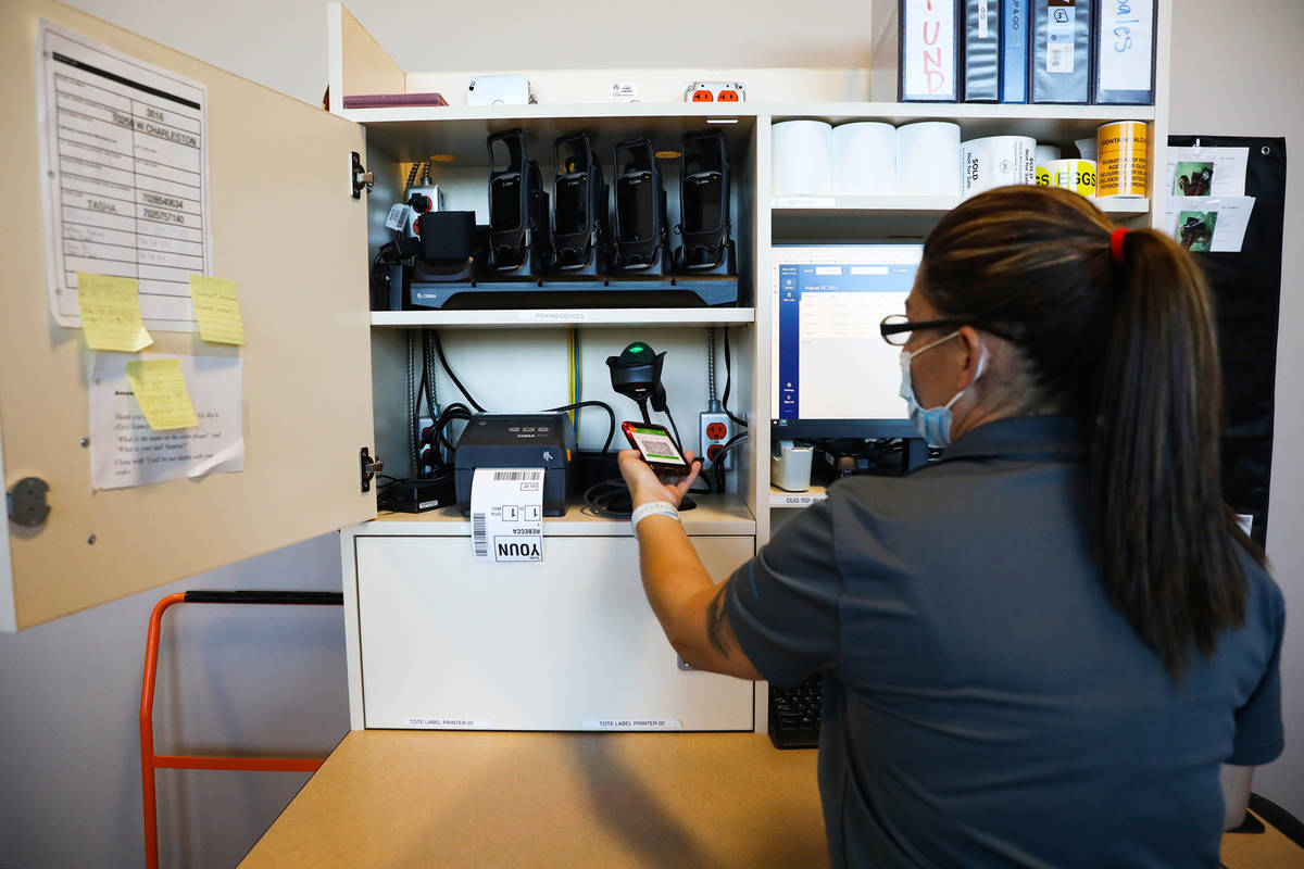 Tasha Tejada, lead for the Drive Up & Go section, demonstrates how an Instacart employee wo ...