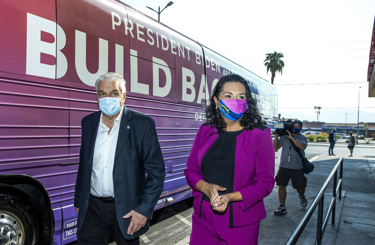 Gov. Steve Sisolak and Las Vegas Councilwoman Olivia Diaz walk by the bus after a tour of the E ...