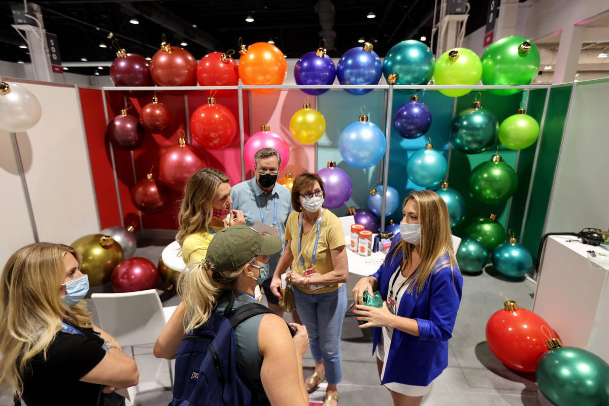 Jennifer Couch of Holiball inflatable ornament, right, shows her product at the Las Vegas Marke ...