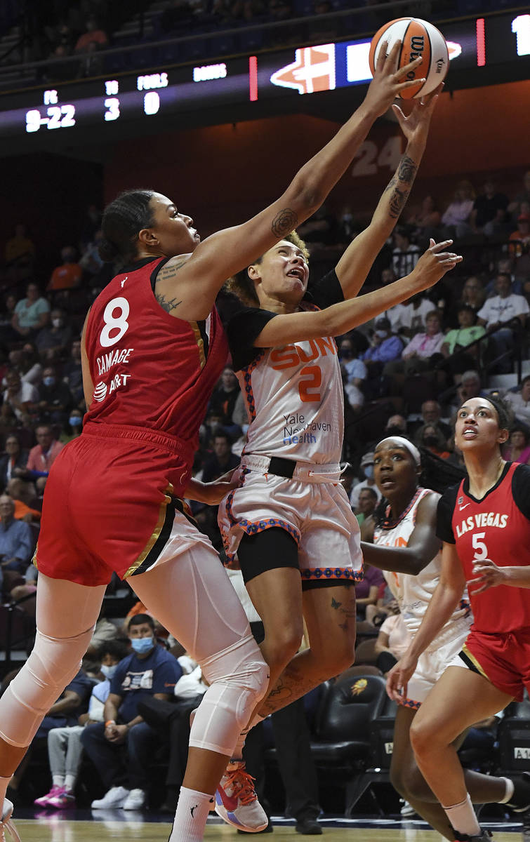 Las Vegas Aces' Liz Cambridge (8) blocks the shot attempt by Connecticut Sun's Natisha Hiedeman ...