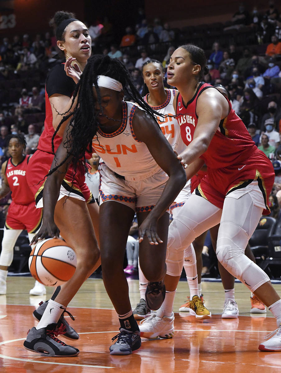 Connecticut Sun's Beatrice Mompremier (1) fights to keep control of the ball against Las Vegas ...