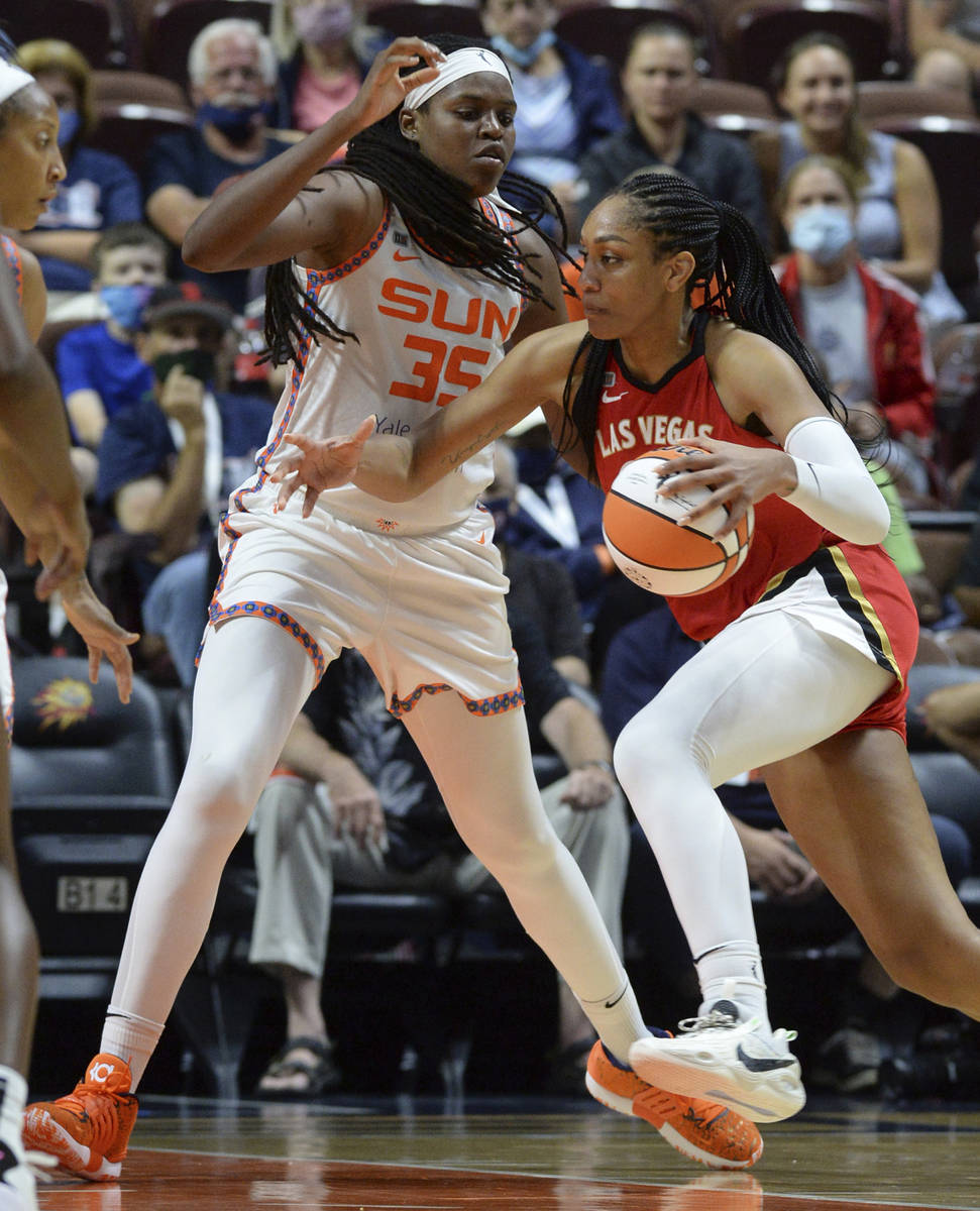 Las Vegas Aces' Aja Wilson (22) drives to the basket against Connecticut Sun's Jonquel Jones (3 ...