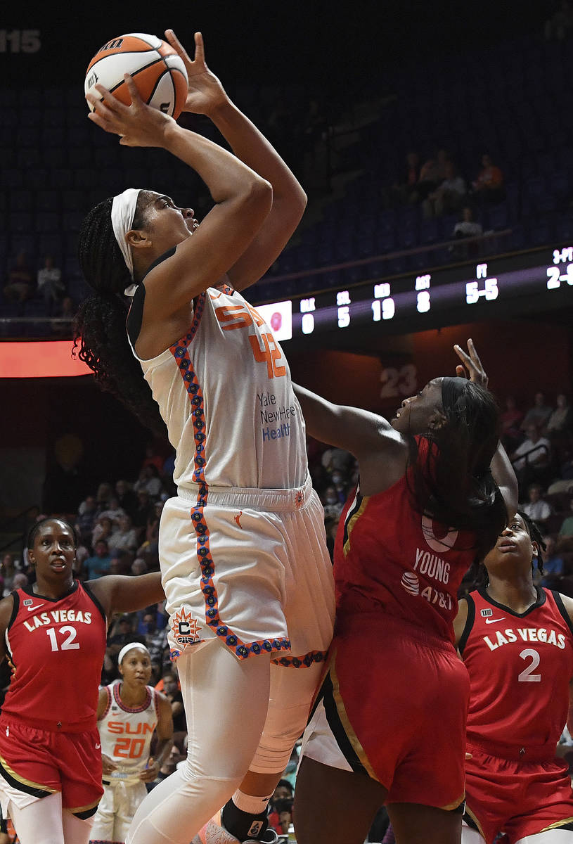 Connecticut Sun center Brionna Jones (42) goes up for a shot against Las Vegas Aces' Jackie You ...