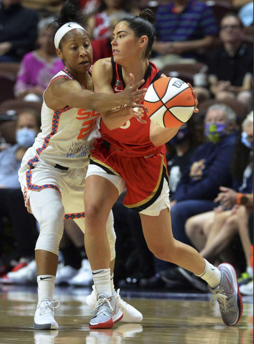 Las Vegas Aces' Kelsey Plum (20) looks to pass against Connecticut Sun's Briann January (20) du ...