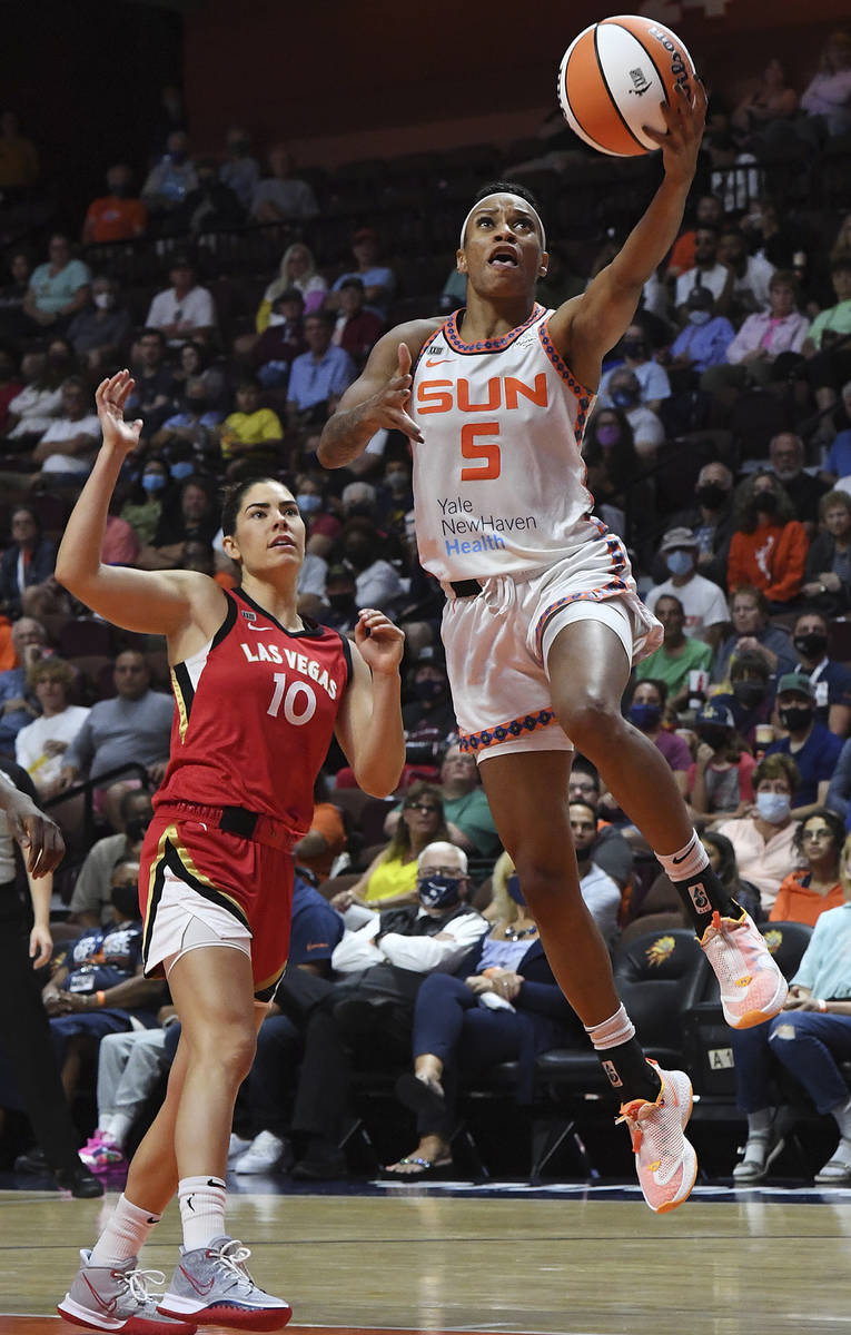 Connecticut Sun's Jasmine Thomas (5) goes up for a shot against Las Vegas Aces' Kelsey Plum (10 ...