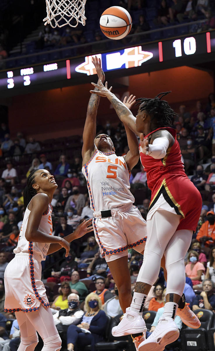 Connecticut Sun guard Jasmine Thomas (5) goes up for a shot against Las Vegas Aces' Riquna Will ...