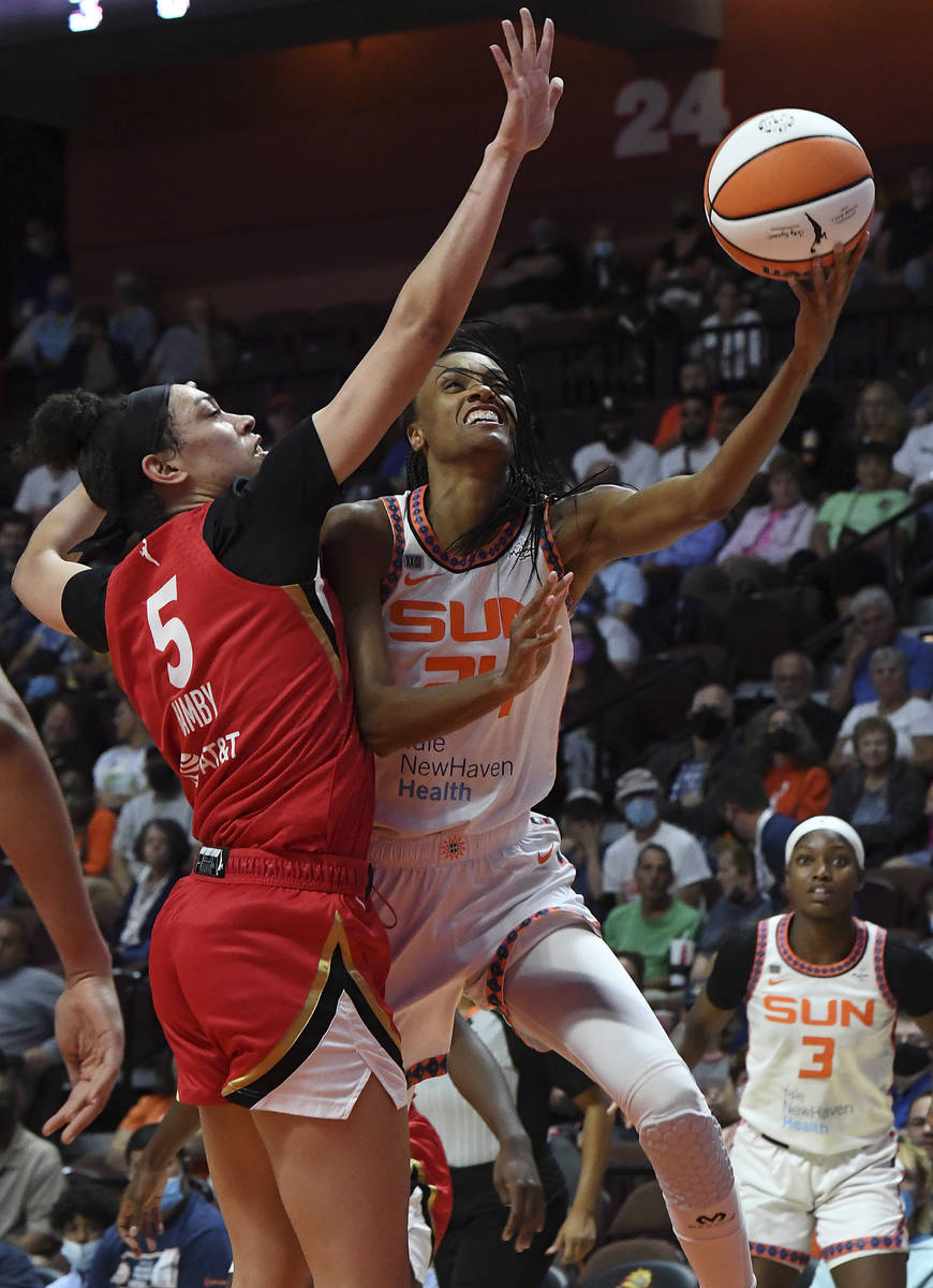 Connecticut Sun's Dewanna Bonner (24) goes up for a shot against Las Vegas Aces' Dearica Hamby ...