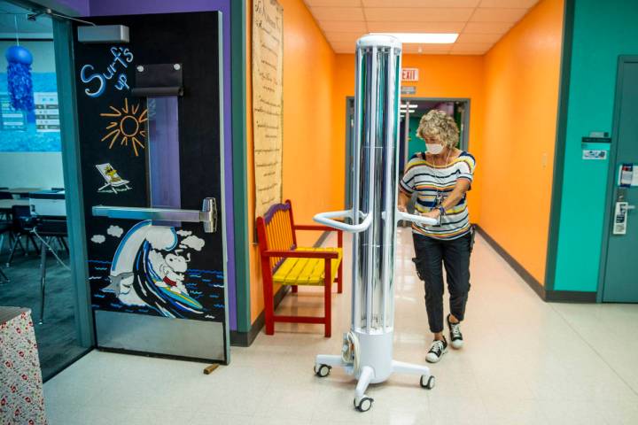 Support staff trainer Lisa Davis wheels in an R-Zero 372 Arc UV-C system as the Clark County Sc ...