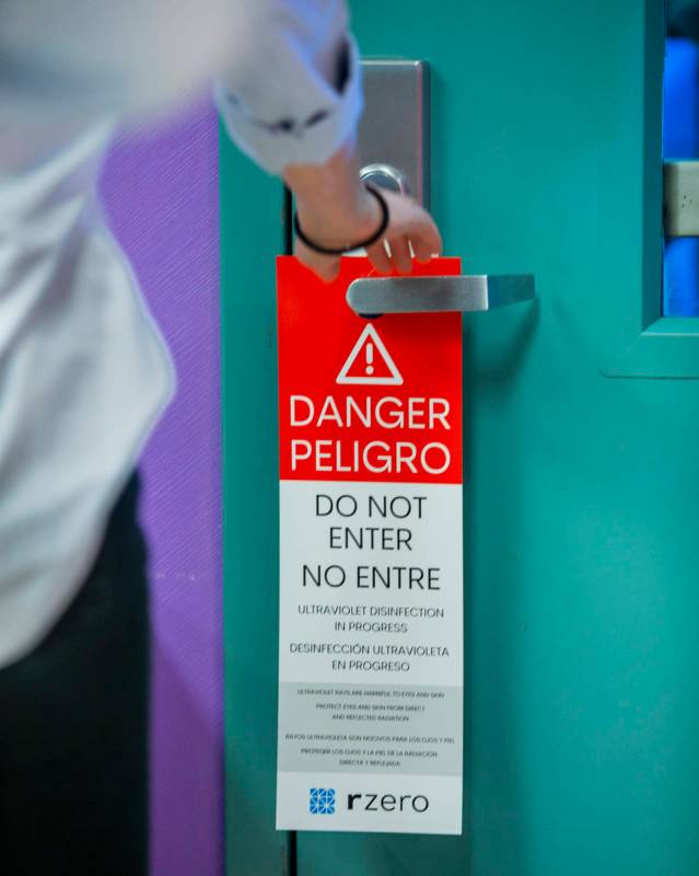 Warning placards are hung on doors when an R-Zero 372 Arc UV-C system is in use, the Clark Coun ...