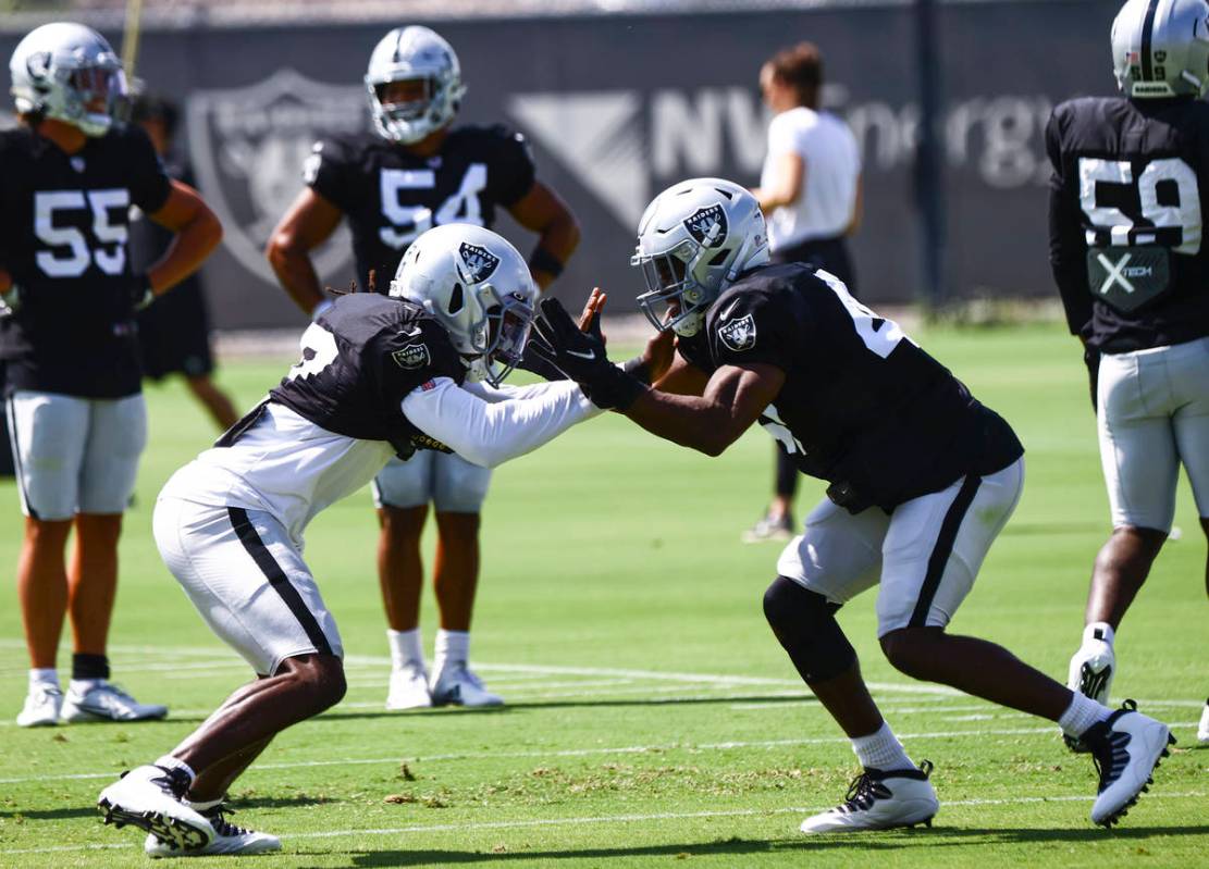 Raiders linebacker Asmar Bilal, left, and safety Divine Deablo run through drills during traini ...