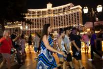 People walk past the Bellagio hotel-casino, on Saturday, July 10, 2021, in Las Vegas. (Bizuayeh ...