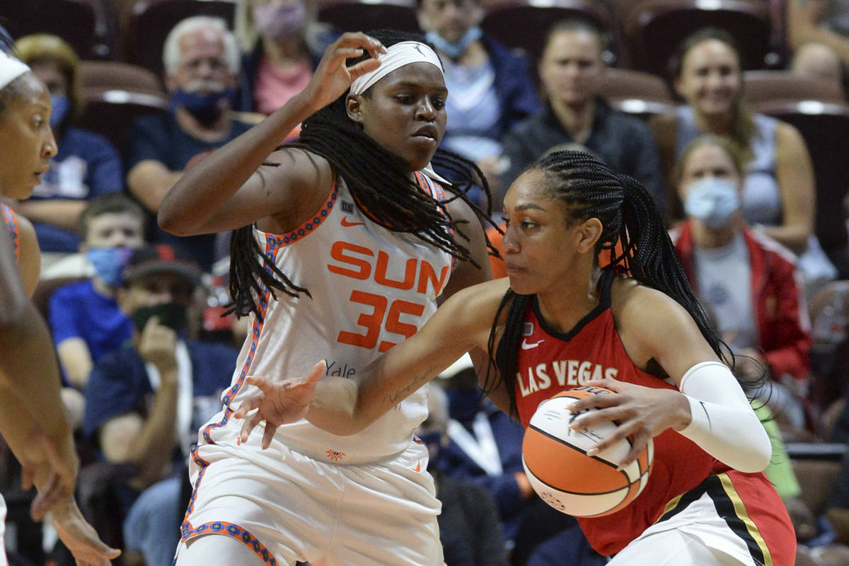 Las Vegas Aces' Aja Wilson (22) drives to the basket against Connecticut Sun's Jonquel Jones (3 ...